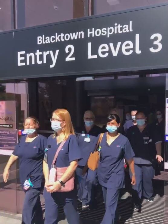 Video still from Facebook of striking Blacktown Hospital nurses walking off the job today. Source: Facebook - https://www.facebook.com/nswnma/videos/391228402067419