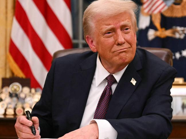 US President Donald Trump signs executive orders in the Oval Office of the White House in Washington, DC, on January 20, 2025. Picture: NewsWire / Jim WATSON / POOL / AFP
