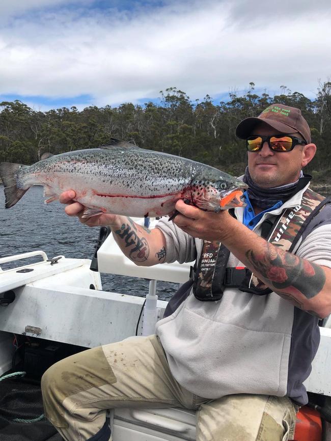 Dave Condon with one of the escapee salmon in the Huon. Photo: Supplied