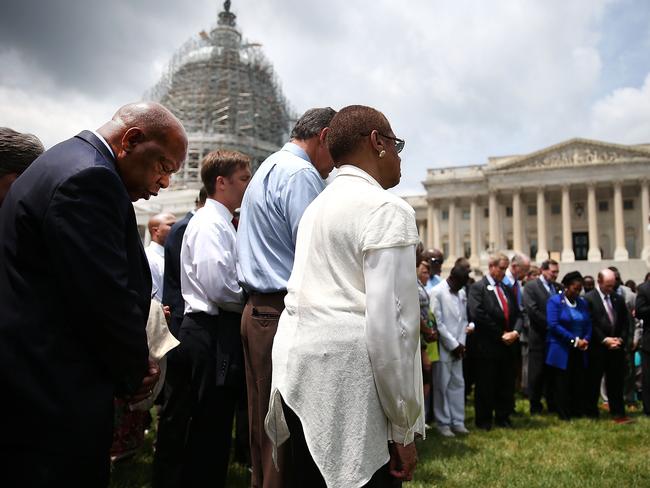 Vigil ... Members of the US House of Representatives and US Senate take part in a prayer circle in front of the US Capitol to honour those killed. Picture: Mark Wilson/Getty Images