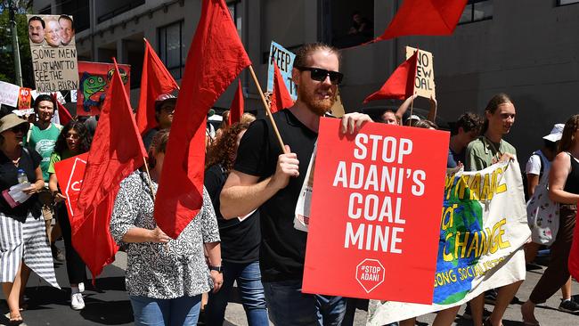 Inner west residents from Stop Adani Sydney hold placards as they march during a rally at Camperdown in Sydney, Sunday, February 17, 2019. (AAP Image/Joel Carrett) NO ARCHIVING