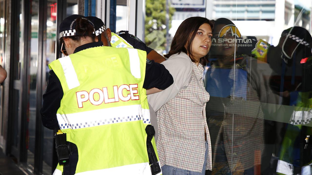 The woman was held against a glass wall to be handcuffed. Picture: NCA NewsWire/Tertius Pickard
