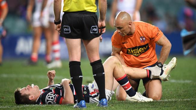 Luke Keary (centre) of the Roosters is expected to miss 3-4 weeks with a knee injury suffered against the Dragons. Picture: AAP Image