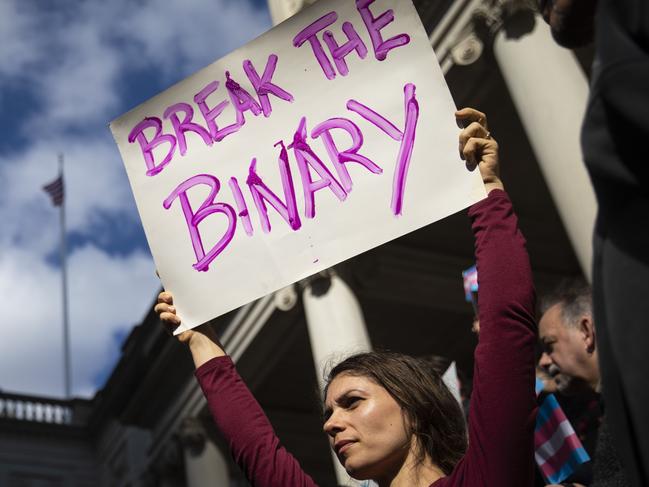 NEW YORK, NY - OCTOBER 24: L.G.B.T. activists and their supporters rally in support of transgender people on the steps of New York City Hall, October 24, 2018 in New York City. The group gathered to speak out against the Trump administration's stance toward transgender people. Last week, The New York Times reported on an unreleased administration memo that proposes a strict biological definition of gender based on a person's genitalia at birth.   Drew Angerer/Getty Images/AFP == FOR NEWSPAPERS, INTERNET, TELCOS & TELEVISION USE ONLY ==