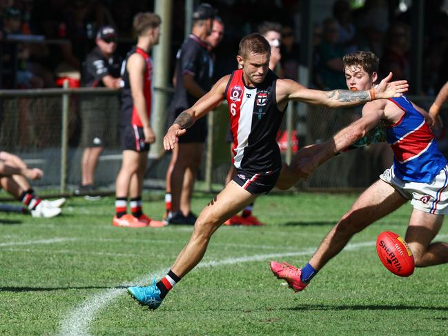 Saints' Chris Novy and Bulldogs' Jaiden Buson contest the loose ball on the boundary line in the AFL Cairns senior men's match between the Cairns Saints and the Centrals Trinity Beach Bulldogs, held at Griffiths Park. Picture: Brendan Radke