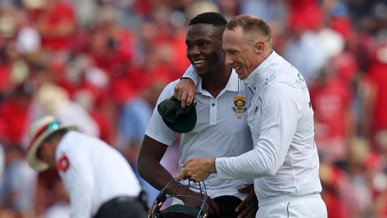 South Africa's Kagiso Rabada (C) leaves the field with South Africa's Rassie van der Dussen (R) after the England Innings having taken 5 wickets.
