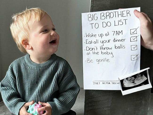 Brit and Joel Selwood with the help of there son Joey, announce they are having another baby. Picture: Instagram