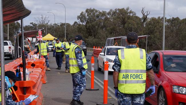 Defence force personnel at the New South Wales border checkpoint at Buronga, near Mildura.