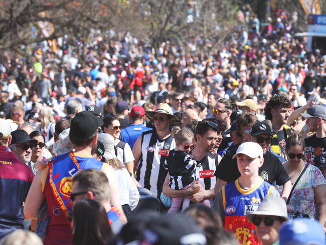 Crowds at the AFL Grand Final Parade at Yarra Park in Melbourne on Friday. Picture Lachie Millard