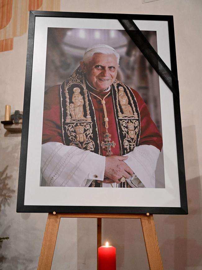 A photograph of late former Pope Benedict XVI is seen during a worship in the Catholic St Oswald church in his birth place Marktl am Inn, southern Germany. Picture: AFP