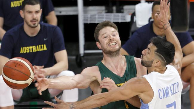 Matthew Dellavedova deals with some close Argentine attention.