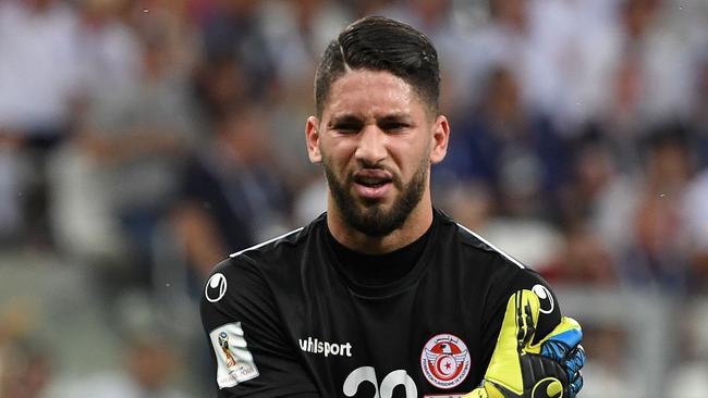 Tunisia's goalkeeper Mouez Hassen touches his shoulder as he leaves the pitch. Pic: AFP