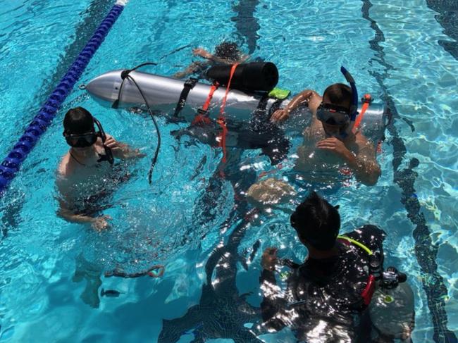 Divers test the device in a pool in Los Angeles. Picture: Elon Musk/ Supplied