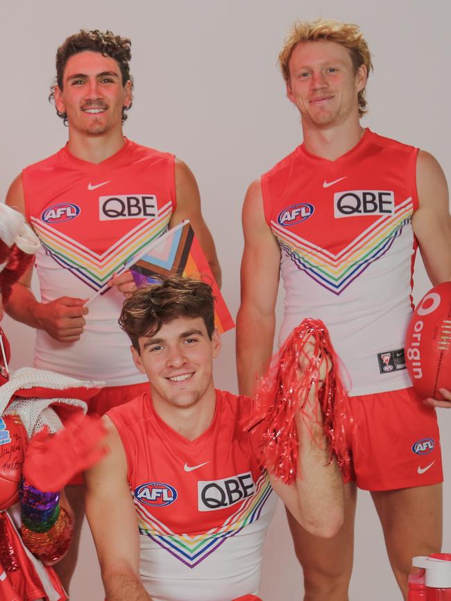 Justin McInerney (left), Errol Gulden (front) and Callum Mills wear the Swans’ special guernsey for the 2023 Pride Game against St Kilda on June 8.