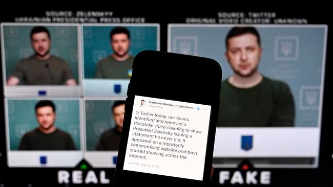 This illustration photo taken on January 30 shows a phone screen displaying a statement from the head of security policy at META with a fake video (R) of Ukrainian President Volodymyr Zelensky calling on his soldiers to lay down their weapons shown in the background, in Washington, DC. (