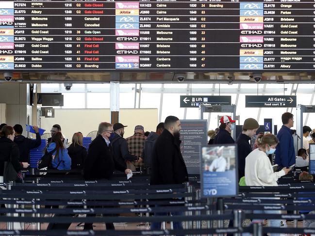 Travellers head towards the security screening point at Sydney Airport. Picture: John Appleyard