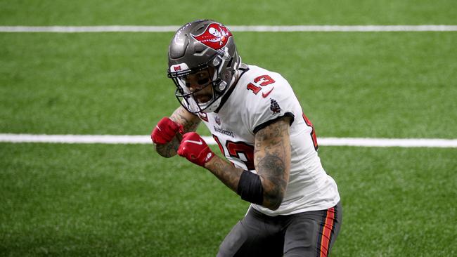 NEW ORLEANS, LOUISIANA - JANUARY 17: Mike Evans #13 of the Tampa Bay Buccaneers celebrates after scoring a 3 yard touchdown against the New Orleans Saints during the second quarter in the NFC Divisional Playoff game at Mercedes Benz Superdome on January 17, 2021 in New Orleans, Louisiana. Chris Graythen/Getty Images/AFP == FOR NEWSPAPERS, INTERNET, TELCOS &amp; TELEVISION USE ONLY ==