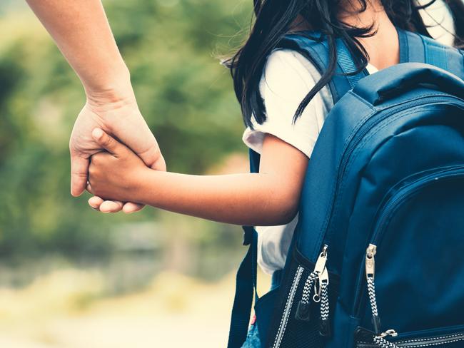 Back to school. Generic photo of child walking with mother from Istock