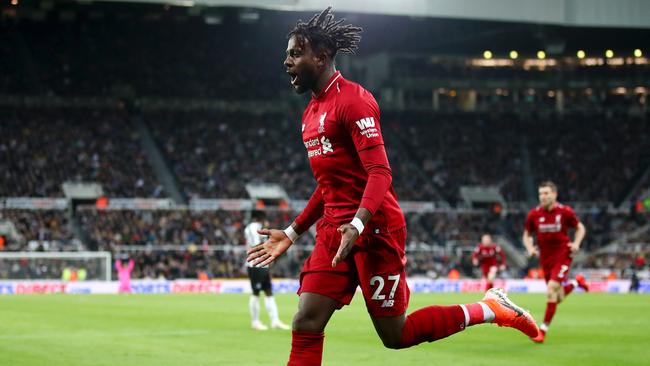 Divock Origi wheels away in celebration after scoring the dramatic, late winner