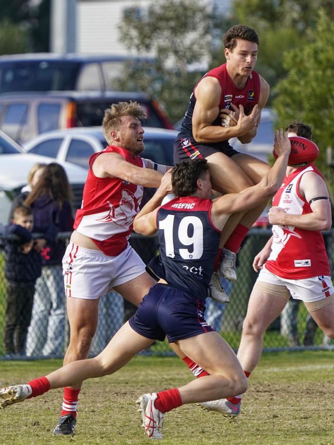 Lachlan Williams flies for a mark for Mt Eliza.