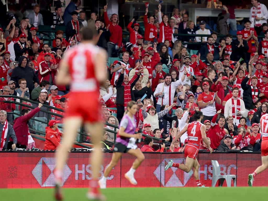 Brodie Grundy celebrates a running goal with the Swans fans. Picture: Cameron Spencer/Getty Images
