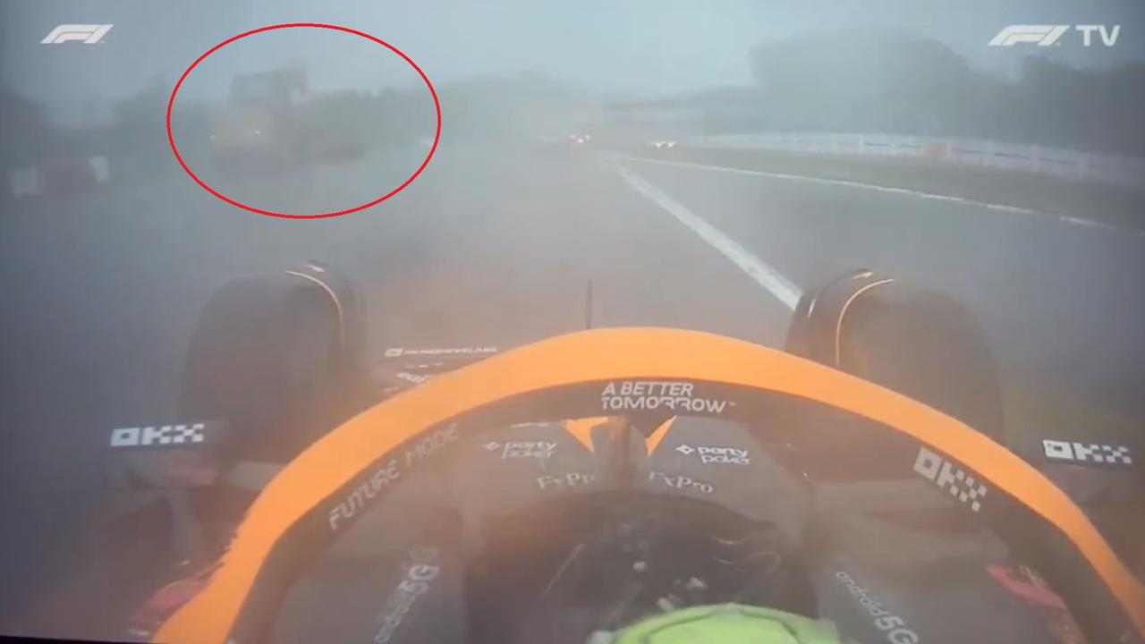 Daniel Ricciardo drives past a tractor.