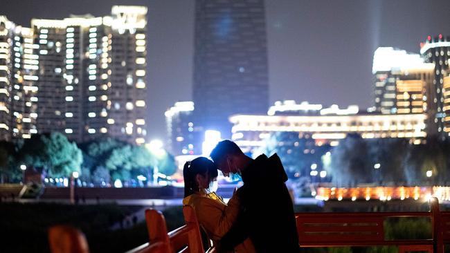 Social distancing dissolves in a park alongside the Yangtze River in Wuhan on Sunday night. Picture: AFP