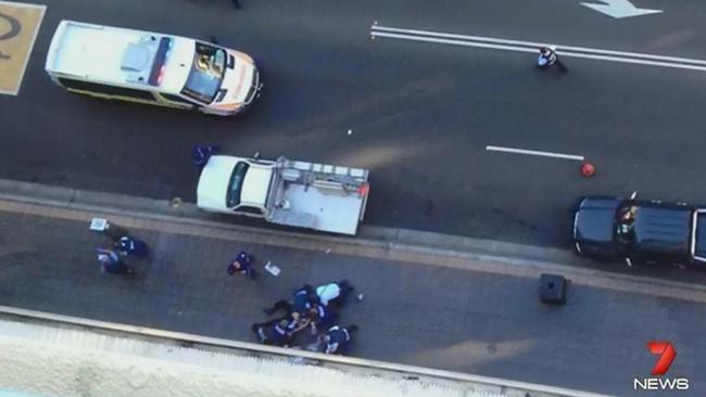 Paramedics and police officers around the body of NSW police worker Curtis Cheng after the October 2015 incident.