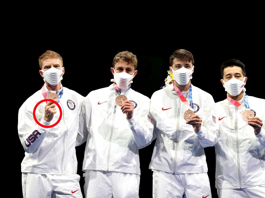 Race Imboden displayed an “X” on his hand on the podium to accept his team bronze medal on Sunday. Picture: Elsa/Getty Images