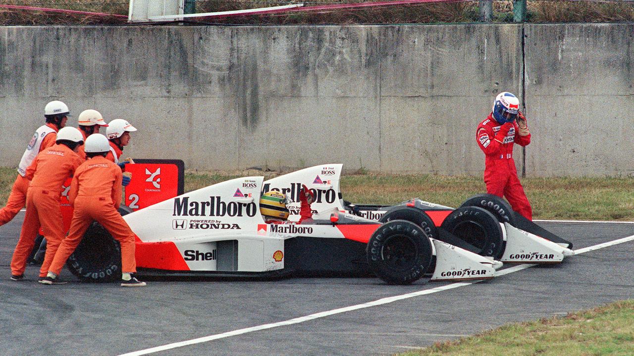 Ayrton Senna reacts while his teammate and rival Alain Prost abandons the 1989 Japan finale following their collision.