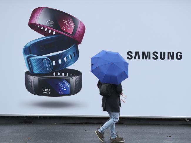 BERLIN, GERMANY - NOVEMBER 01: A person with an umbrella walks past a advertisement for the Samsung Fit2 sports band on November 1, 2016 in Berlin, Germany. Samsung is continuing to grapple with the crisis of its Galaxy Note 7 smartphone catching fire. Co-CEO Kwon Oh-hyun said today he sees the crisis as a catalyst to propel the company towards a fresh start. (Photo by Sean Gallup/Getty Images)