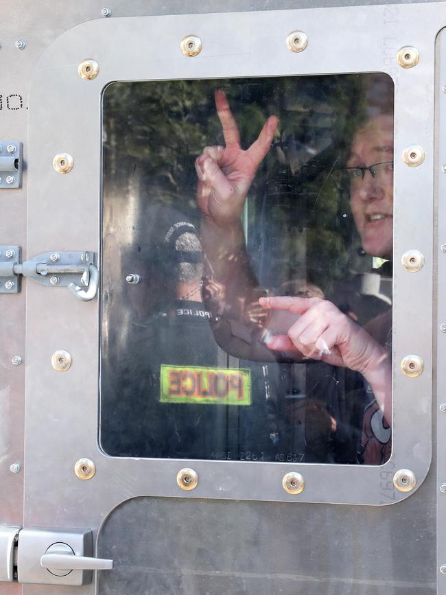 A young man is detained by police during yesterday’s protests. Picture: Liam Kidston