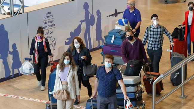 Israelis and vaccinated tourists wearing masks for Covid-19 protection arrive to Israel's Ben Gurion Airport near Tel Aviv on May 23, 2021, after a partial reopening of the border to inoculated tourists from 14 countries. Picture: AFP