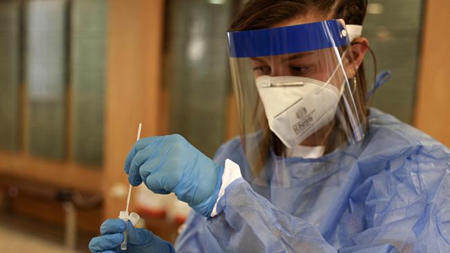 A paramedic in Jerusalem processes a Covid-19 test. Picture: AFP