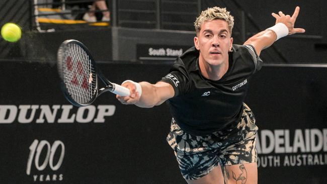 Thanasi Kokkinakis hits a return against USA's Maxime Cressy during their men's singles match at the Adelaide International tennis tournament on January 2. Picture: Brenton Edwards/AFP