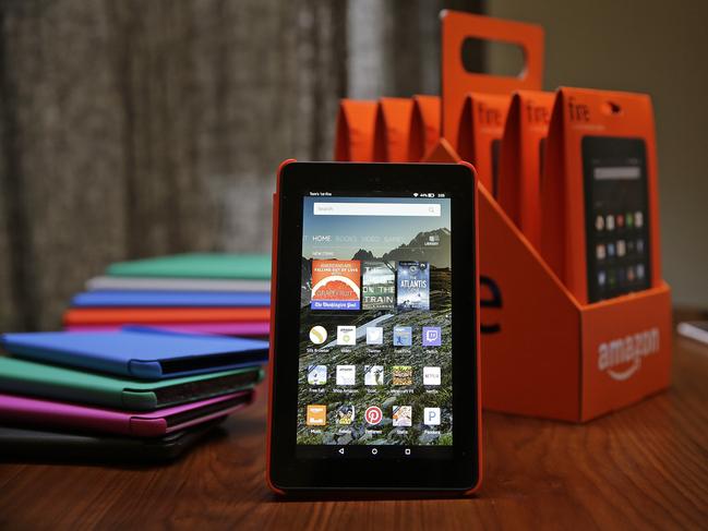 In this Wednesday, Sept. 16, 2015, photo, Amazon's new $50 Fire tablet is displayed next to a six-pack of them and assorted colored cases in San Francisco. Amazon.com is introducing the $50 tablet computer in its latest attempt to boost its online store sales by luring consumers who can’t afford more expensive Internet-connected devices made by Apple and other rivals. (AP Photo/Eric Risberg)