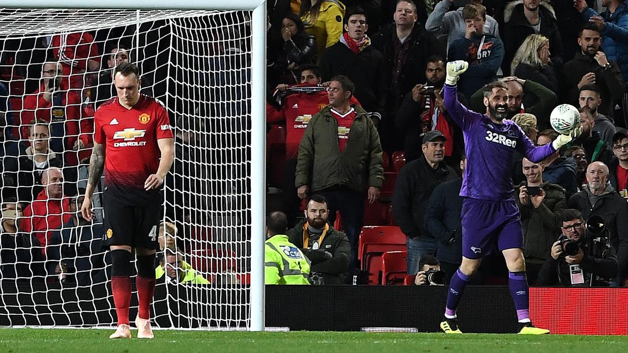 A dejected Phil Jones (L) after Derby's keeper Scott Carson (C) saved his penalty. Picture: AFP