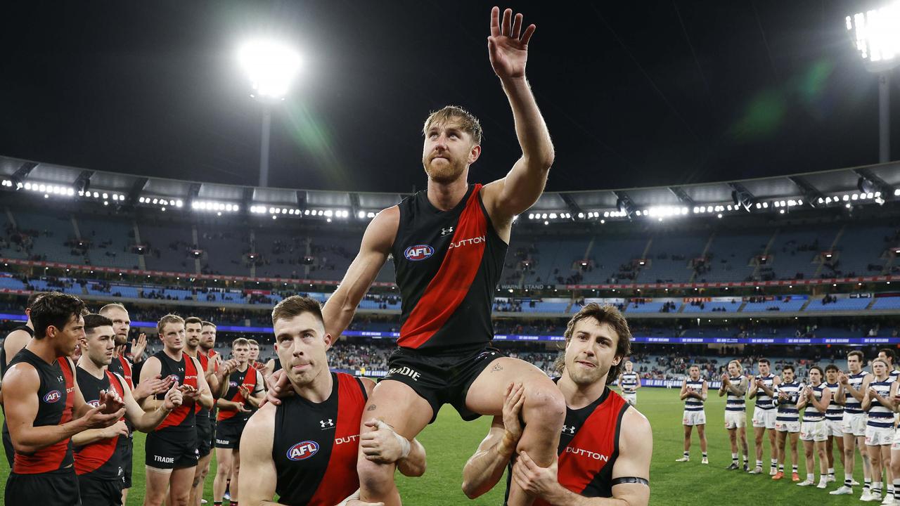Former Essendon captain and club champion Dyson Heppell was chaired off by teammates Zach Merrett (left) and Andy McGrath (right) following his 250th game. Picture: Michael Klein