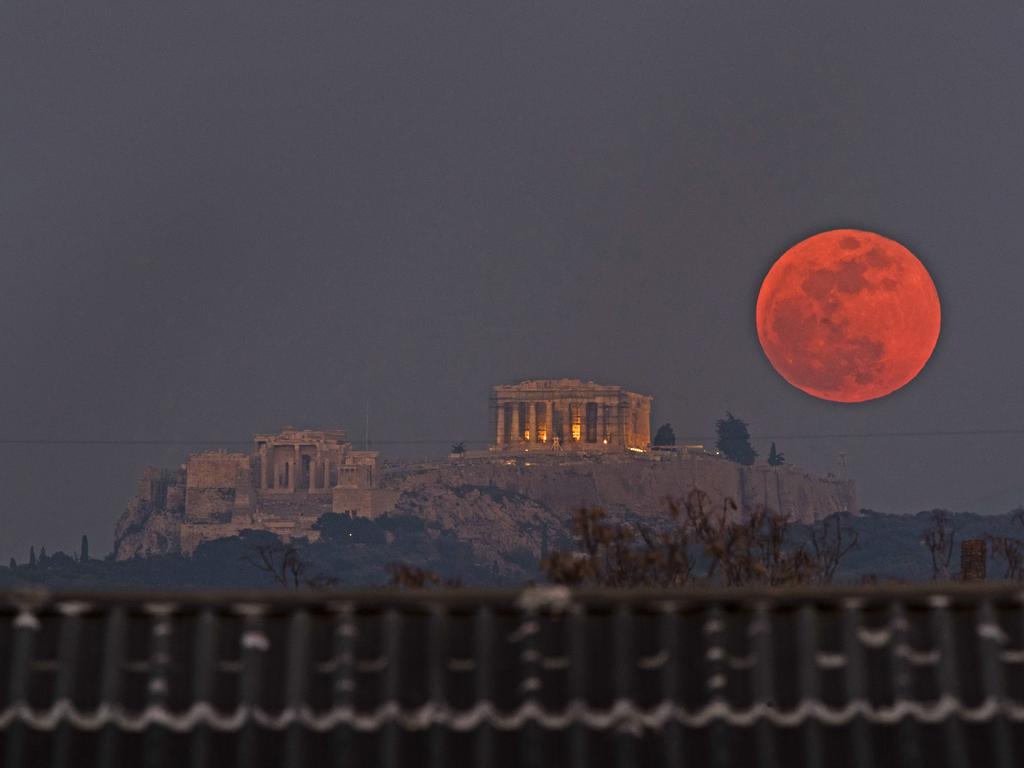 A super blue blood moon rises behind the 2,500-year-old Parthenon temple on the Acropolis of Athens, Greece, on Wednesday, Jan. 31, 2018. On Wednesday, much of the world will get to see not only a blue moon which is a supermoon, but also a lunar eclipse, all rolled into one celestial phenomenon. Picture: AP