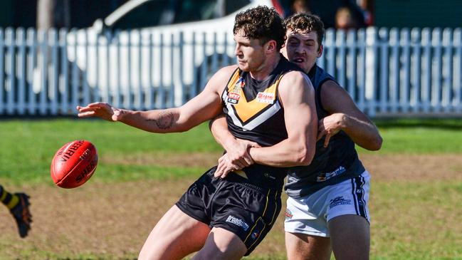 AUGUST 21, 2021: BrightonÃs Otis Carthy kicks under pressure during Adelaide Footy League division one match between Brighton Bombers and Port District at Brighton Oval. Picture: Brenton Edwards