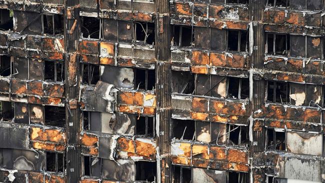 The charred remains of cladding are pictured on the outer walls of the burnt out shell of the Grenfell Tower block in north Kensington, west London. AFP PHOTO