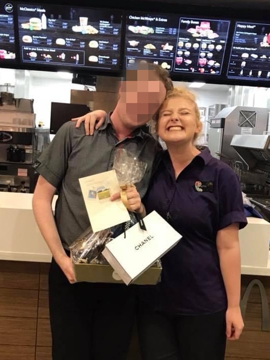 Kitty pictured with a manager celebrating his last day. Picture: Facebook