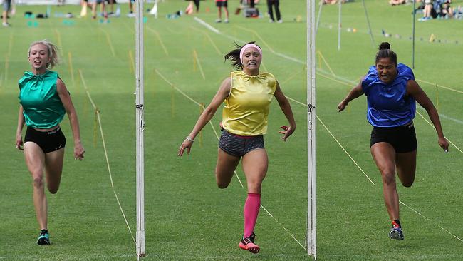 Jessica Payne (yellow) wins the 2016 Women's 120m Bay Sheffield race from Patricia Taea (blue and Mikayla Round (green) at Colley Reserve, Glenelg. Picture: Dylan Coker.