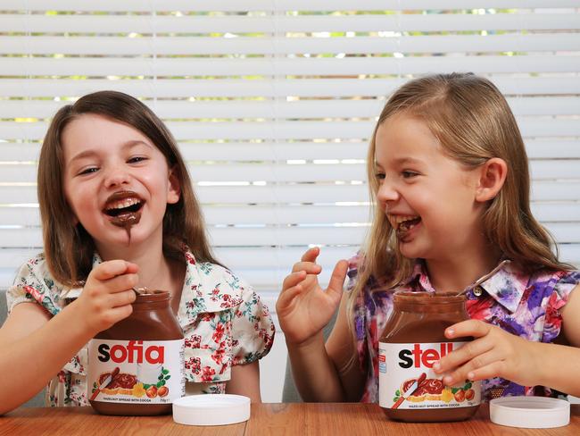 Sisters Sofia (L) and Stella Hutchens are excited about their personalised Nutella jars at their Gymea home. Picture: Toby Zerna