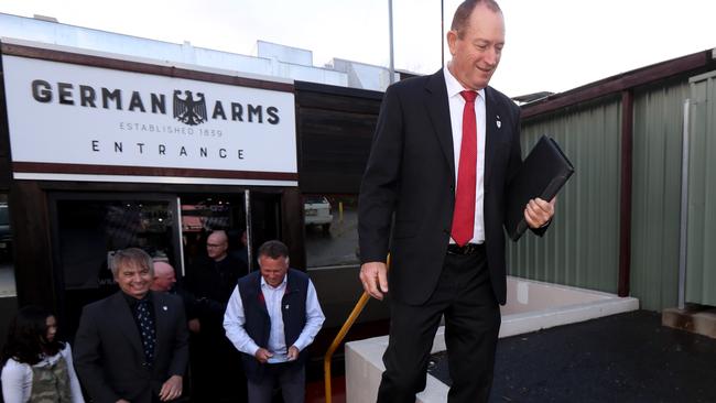 Senator Fraser Anning (right) leaves a press conference at the German Arms Hotel in Hahndorf. Picture: AAP / Kelly Barnes