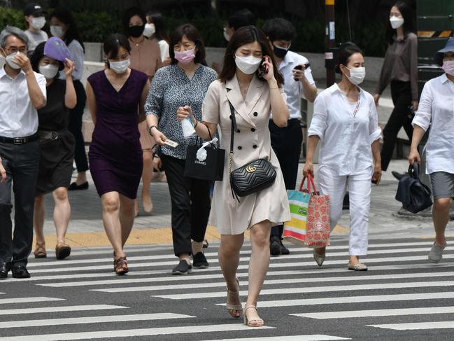 Pedestrians wearing face masks in central Seoul, South Korea, which has battled a second wave of COVID-19 infections. Picture: AFP