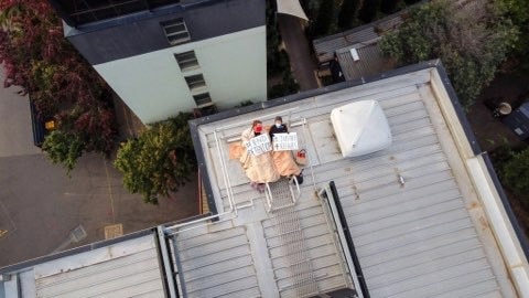 Some protesters have chained themselves to the hotel’s roof. Picture: Supplied