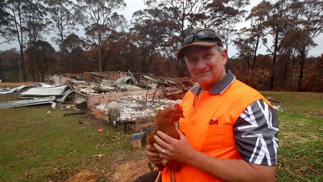 RFS volunteer Steve Hillyar in front of the remains of his home on Blackbutt Lane in Malua Bay. Picture: Toby Zerna