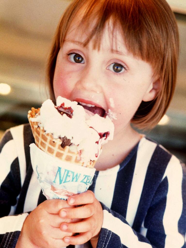 Child licking ice-cream cone.  icecream eating /Ice/cream /Eating /Children