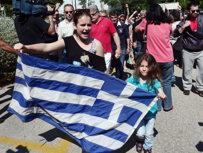 What austerity looks like ... former employees of the national Greek broadcaster ERT enter the broadcaster's headquarters in Athens last month, demanding their jobs back after the Greek parliament abruptly closed the service in 2013 as part of austerity measures. Picture: AFP Photo / Louisa Gouliamaki